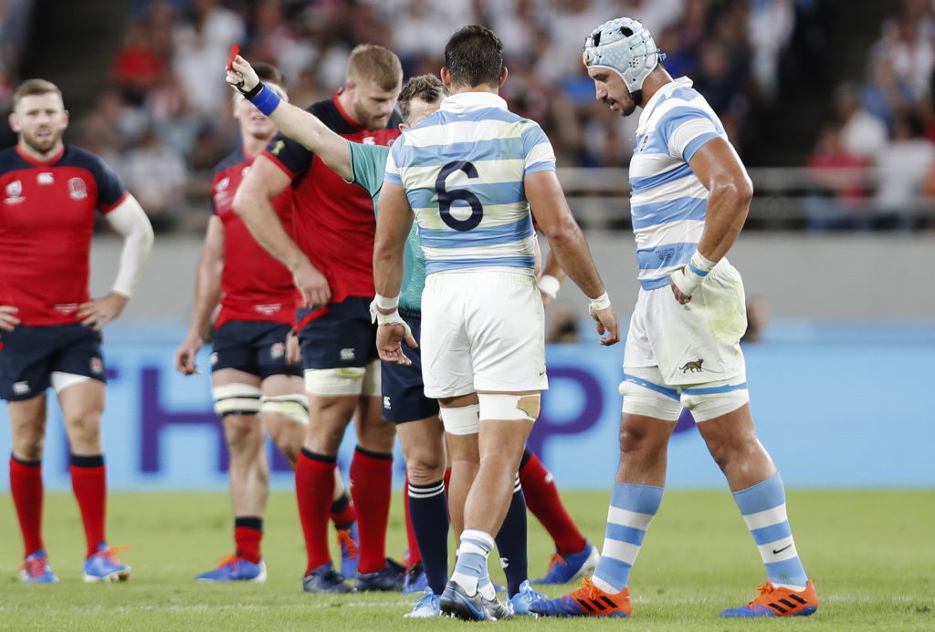 Tomas Lavanini receives a red card from Nigel Owens