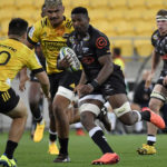 Bok hopeful Sikhumbuzo Notshe of the Sharks avoids a tackle by Jackson Garden-Bachop of the Hurricanes during the round 3 Super Rugby match between the Hurricanes and the Sharks at Westpac Stadium