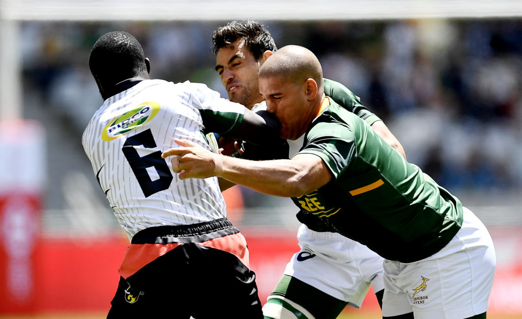 Jeff Oluoch of Kenya tackled by Chris Dry and Zain Davids of South Africa during day 3 of the 2019 HSBC Cape Town Sevens