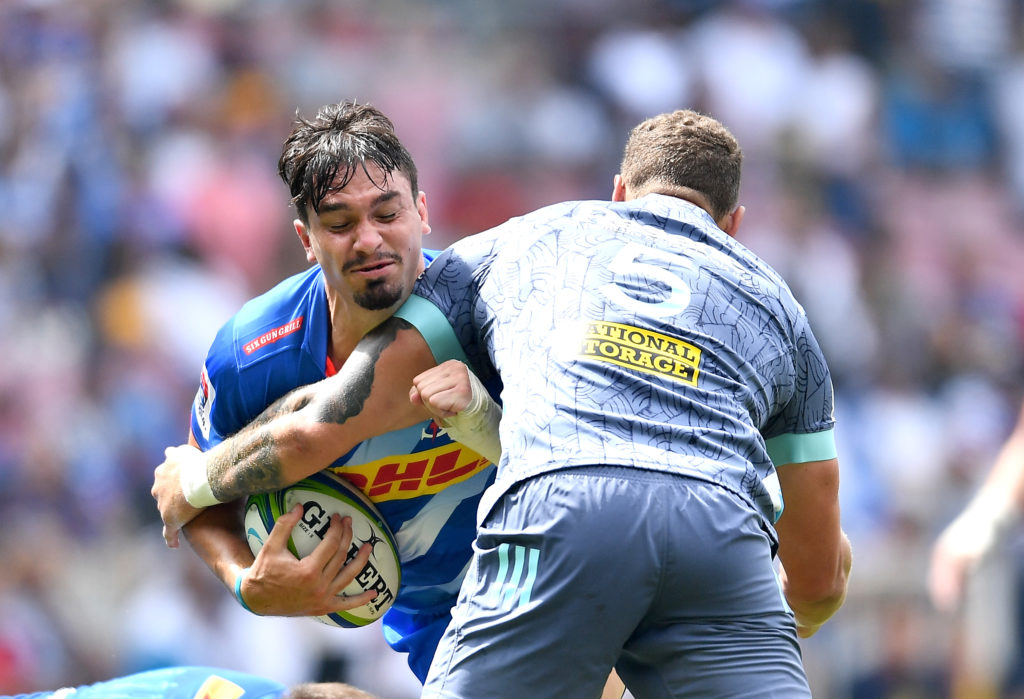 Jaco Coetzee tackled against the Hurricanes