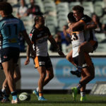 Brumbies back Tom Wright celebrates scoring a try