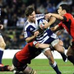 Dan Carter tackles Schalk Brits in Super Rugby