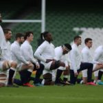 England's players line up during the 'taking the knee' minute ahead of the Six Nations international rugby union match between Ireland and England at the Aviva Stadium in Dublin, on March 20, 2021. (Photo by Niall Carson / POOL / AFP)