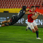 SOUTH AFRICA - JULY 07: Valiant effort from Thaakir Abrahams of the Cell C Sharks to tackle the try scorer Josh Adams of the British & Irish Lions during the Tour match between Cell C Sharks and British and Irish Lions at Emirates Airline Park on July 07, 2021 in Johannesburg, South Africa.